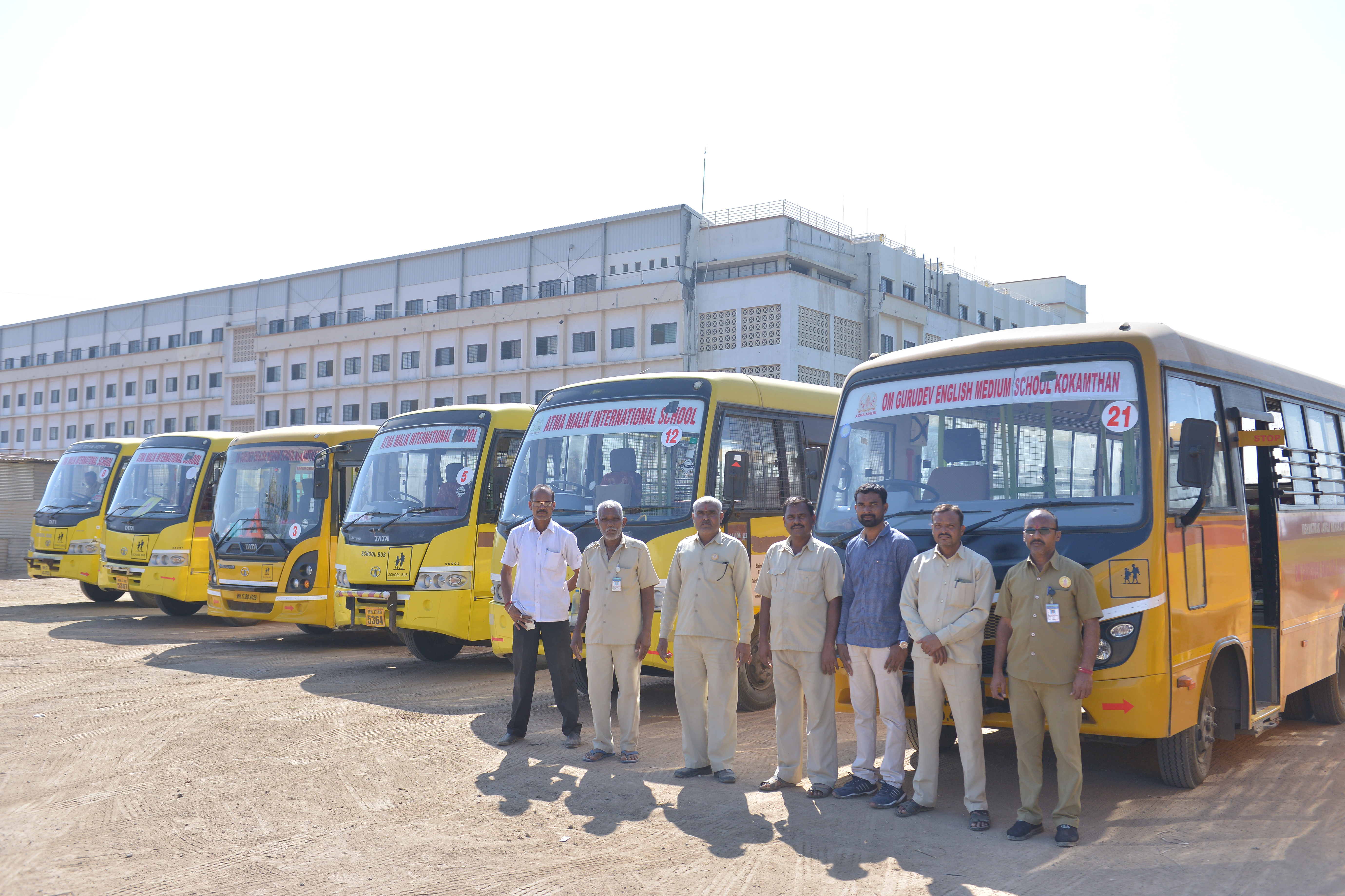 College buses lined up in front of the campus buildings